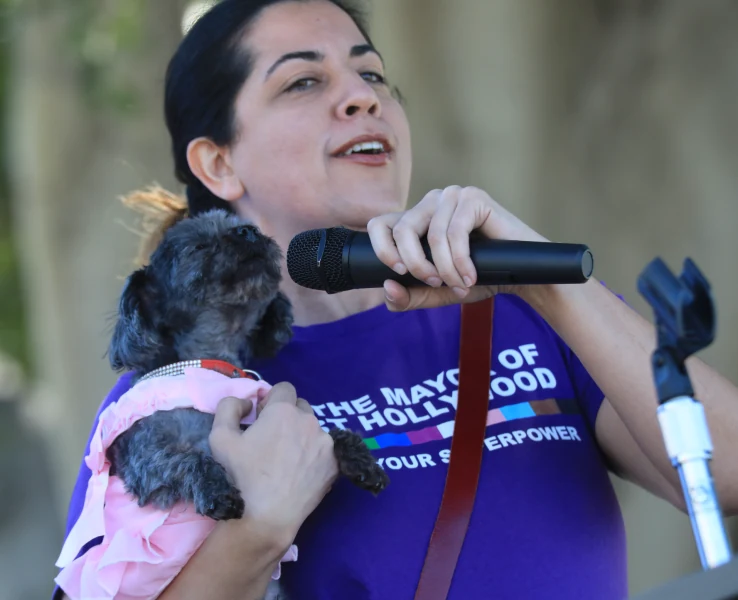 Mayor Sepi Shyne and her dog, Chloe the Queen of WeHo, howl in unison with the audience at Chloe’s inauguration as WeHo’s first pet mayor on April 1, 2023 at West Hollywood Park.